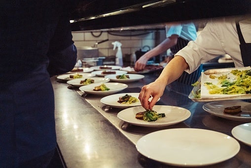 Closeup shot of the chefs preparing a fine dinner at the kitchen in a restaurant in London, England