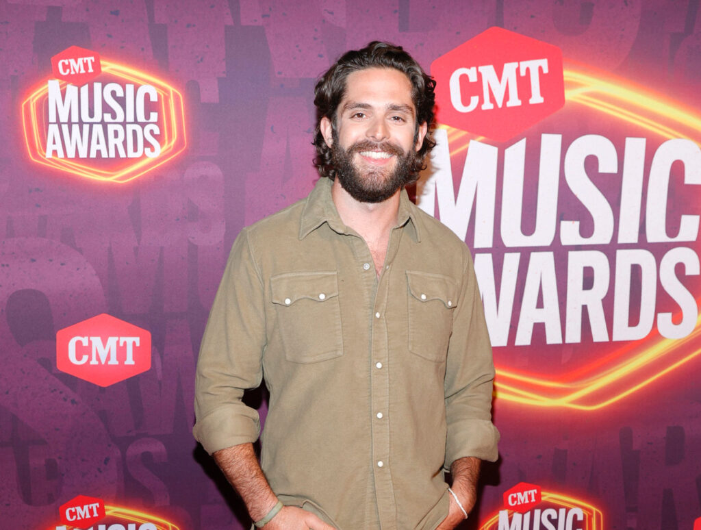 Thomas Rhett's music video - Thomas on the CMT red Carpet wearing a tan shirt. 