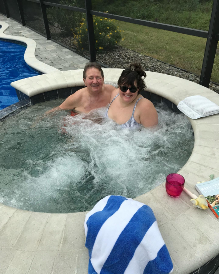 Nicole and her dad Chet sitting in a hot tub