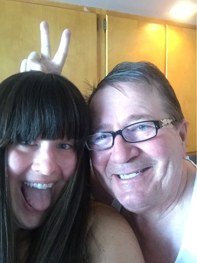 Nicole and her dad as he puts bunny ears behind her head