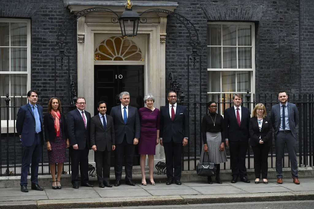 LONDON, ENGLAND - JANUARY 08: (L to R) James Morris (Vice Chair, Training and Development ), Helen Grant (Vice Chair, Diverse Communities ), Marcus Jones (Vice Chair Local Government), Rehman Chishti (Vice Chair, Diverse Communities), Brandon Lewis (Chair), Prime Minister Theresa May, James Cleverly (Deputy Chair), Kemi Badenoch (Vice Chair for Candidates), Chris Skidmore (Vice Chair, Policy), Maria Caulfield (Vice Chair for Women), Ben Bradley (Vice Chair for Youth) pose outside 10 Downing Street as the Prime Minister Reshuffles her cabinet on January 8, 2018 in London, England. Today's Cabinet reshuffle is Theresa May's third since becoming Prime Minister in July 2016 and was triggered after she sacked first secretary of state and close friend Damian Green before Christmas. (Photo by Leon Neal/Getty Images)