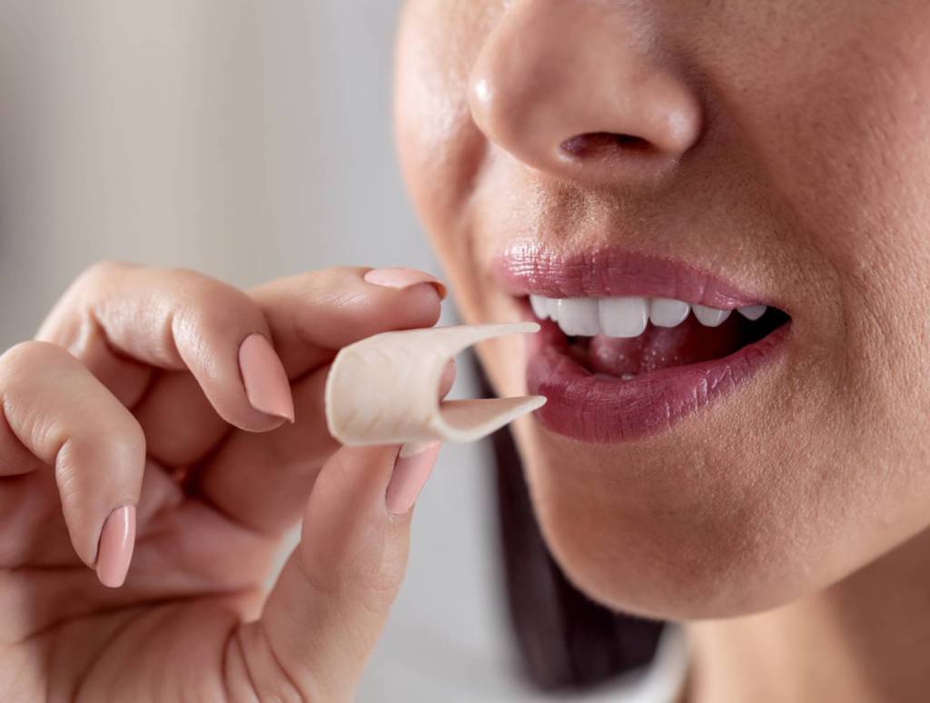 Woman putting gum in her mouth